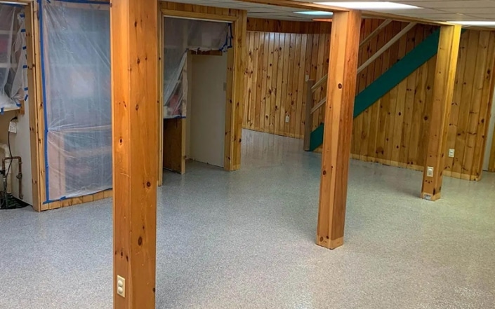 Interior of basement with concrete coated floor.