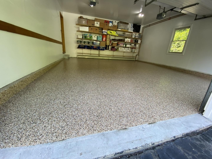 Interior of garage with concrete coated floor.