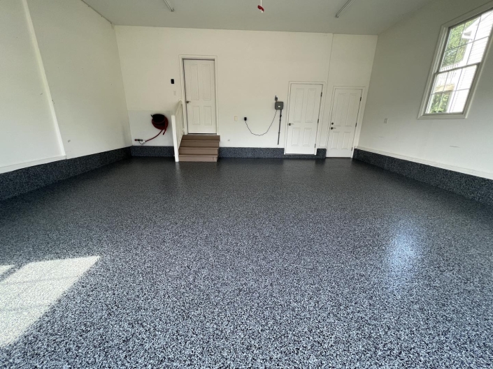 Interior of garage with concrete coated floor.