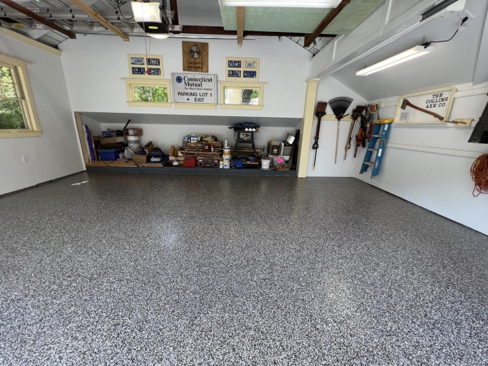 close up of flecked concrete coated garage floor.