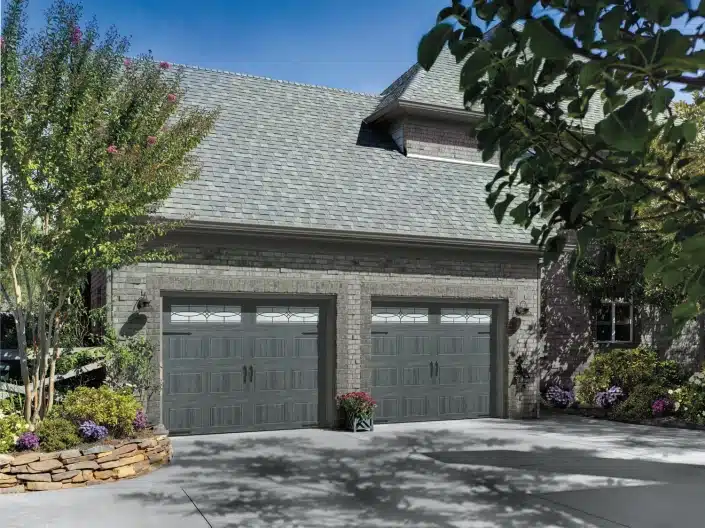 A nice home with a 2 car garage and custom double garage doors.