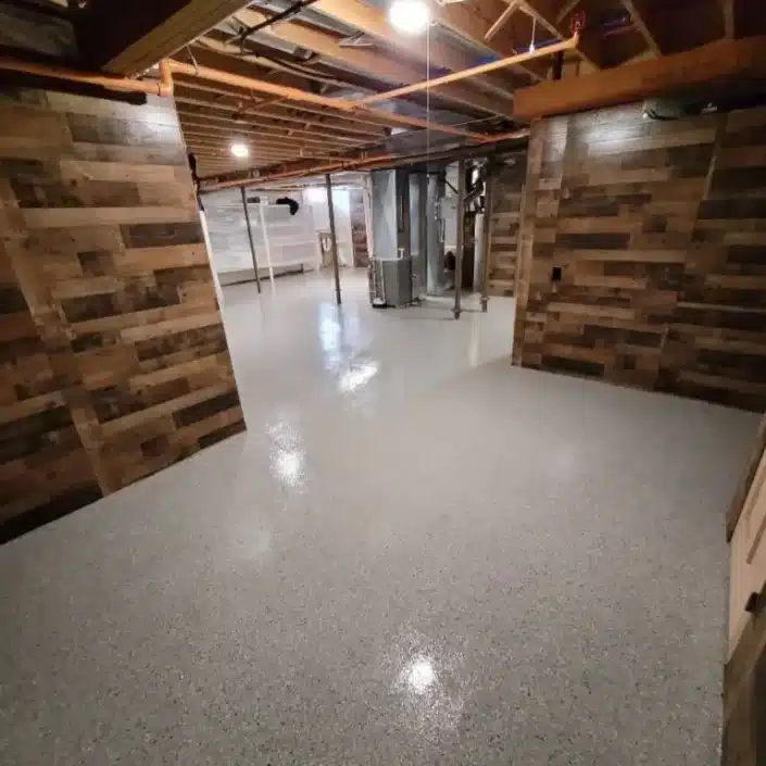 Interior of basement with concrete coated floor.